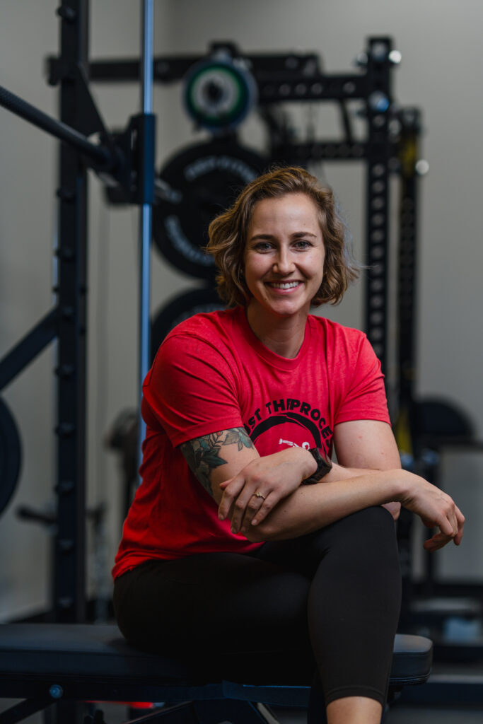 Pflugerville physical therapists and personal trainer, Dr. Morgan Riggins, sitting inside the Pflugerville gym called Bodies By Design.